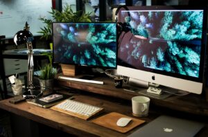 LLM UX Design support picture with two computer monitors turned on with the same wallpaper